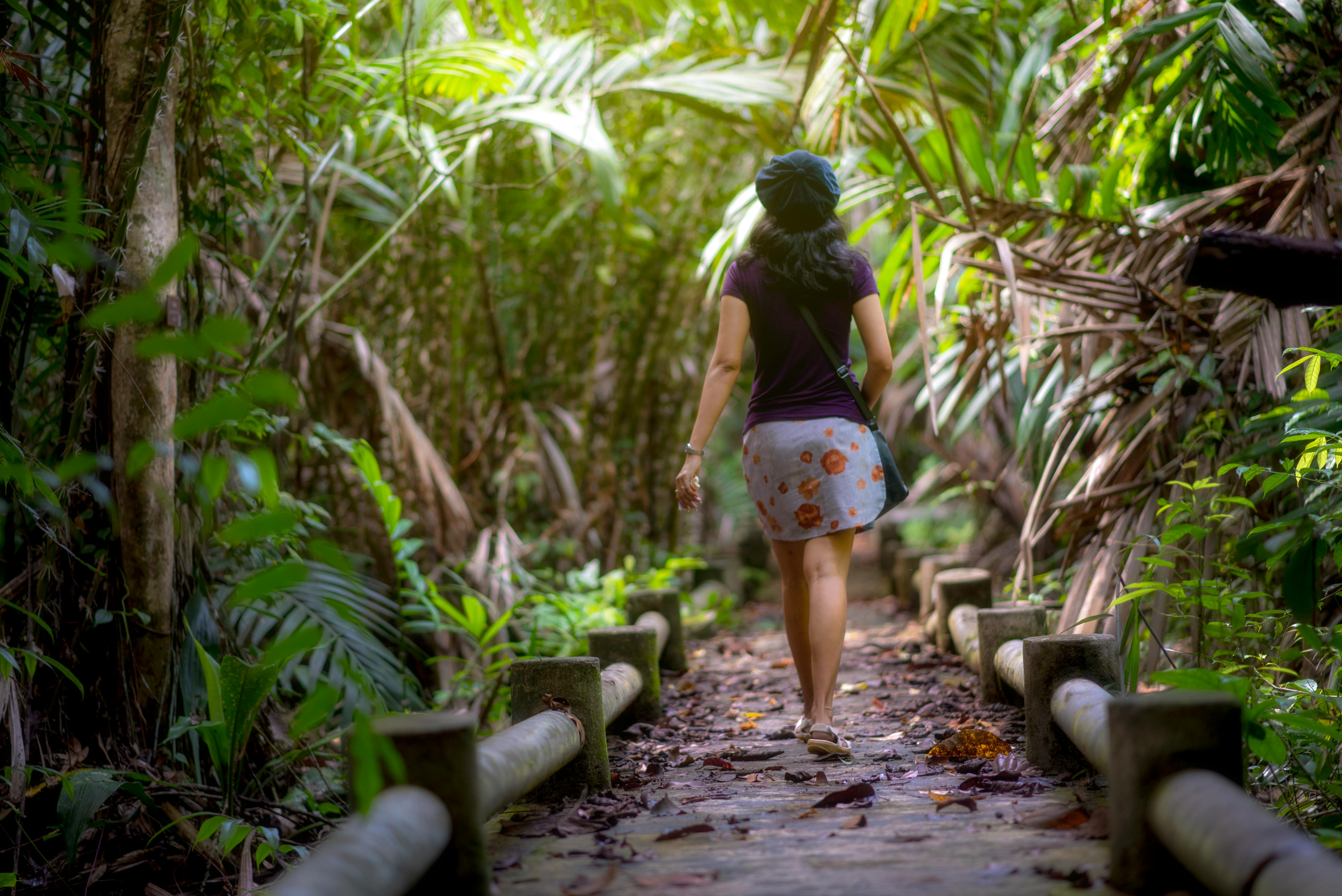 Woman walking along a green nature path
