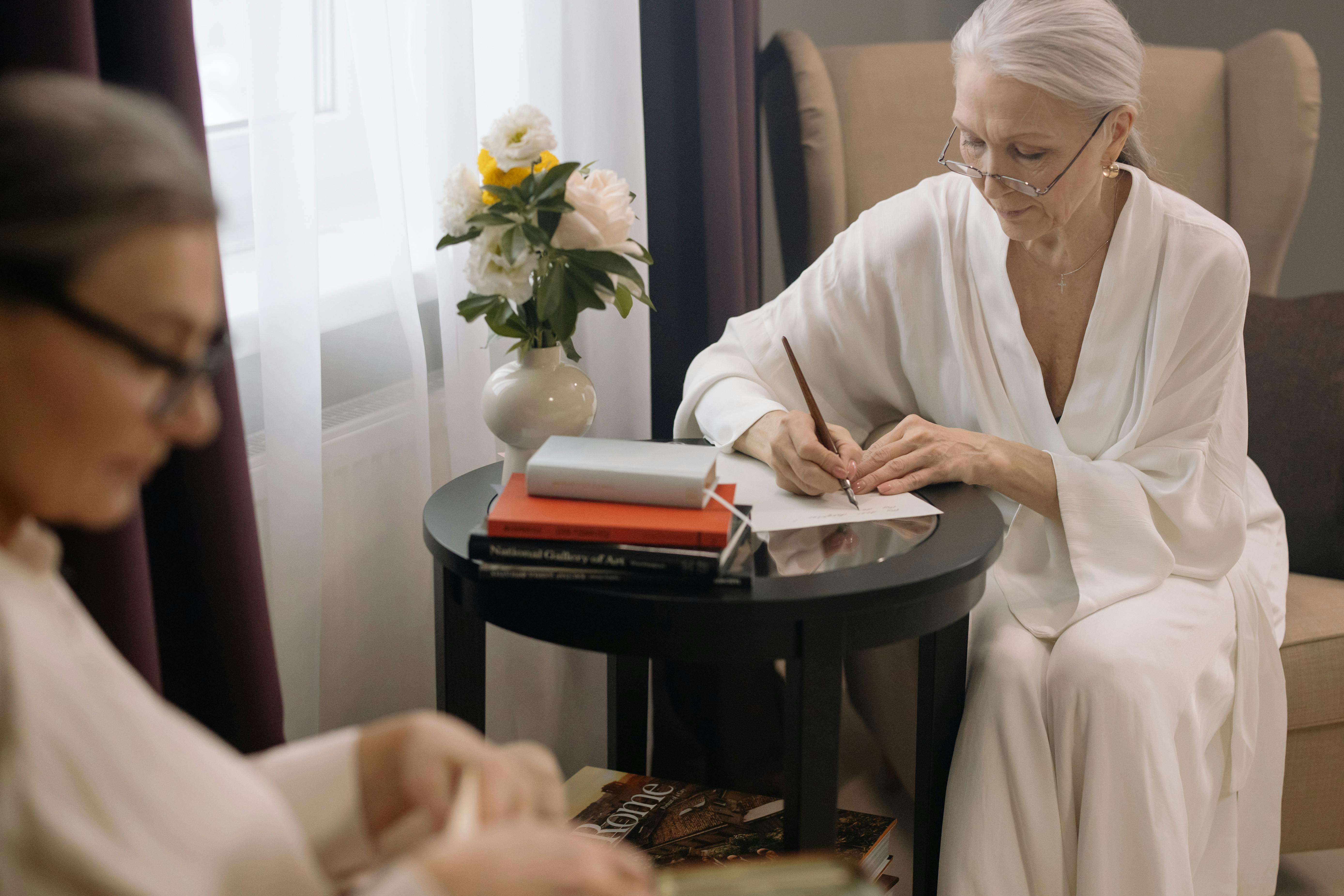 Woman writing thoughtful notes at a small table